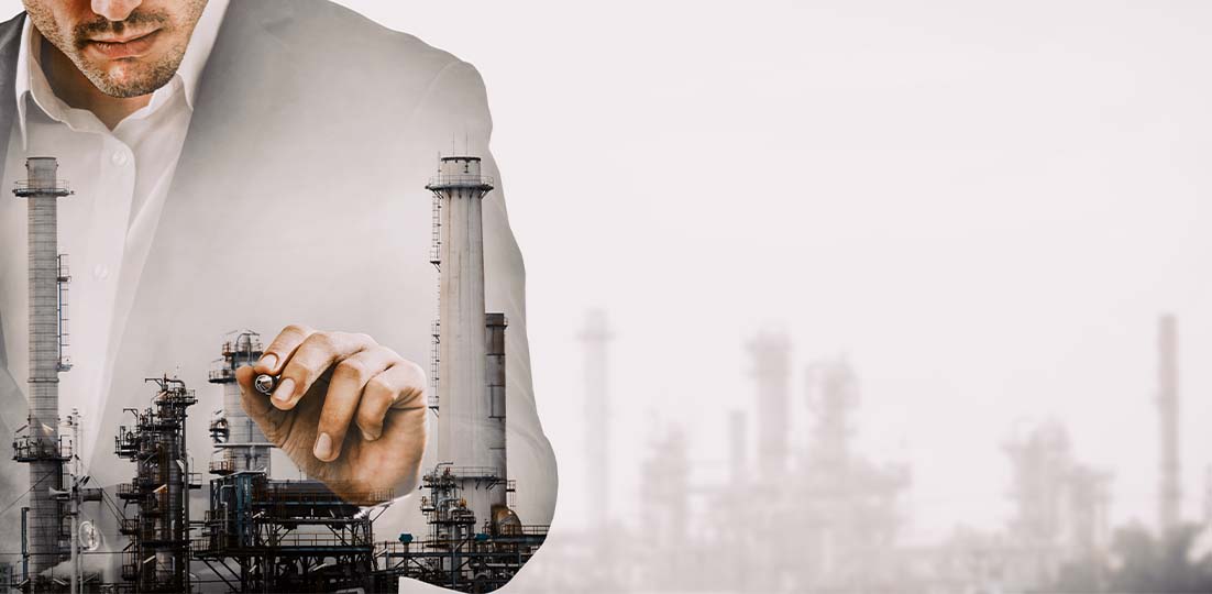 Engineer planning over a refinery skyline